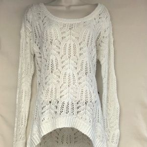 Cream colored sweater With embroidered pattern.